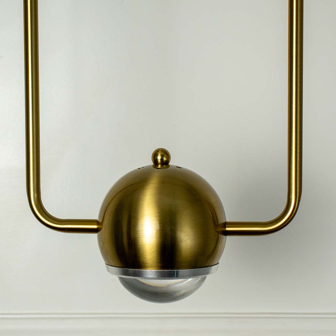 Stylish brass gold wall lamp with rectangular frame and globe light shade crafted in metal for bedroom and hallway decor.