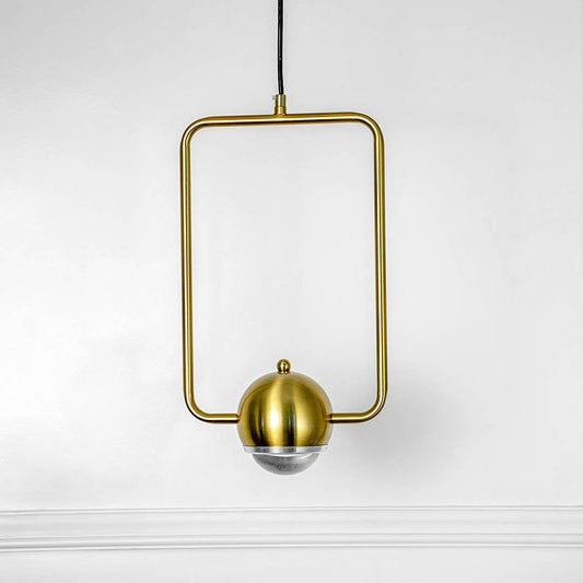 Gold square frame pendant light with central bulb holder and hanging cord placed against neutral wall background showcasing geometric modern lighting decor styling.