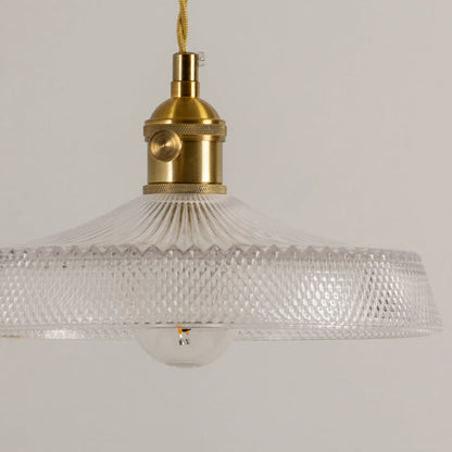 Detailed view of clear textured glass pendant light with gold accents highlighting premium design.