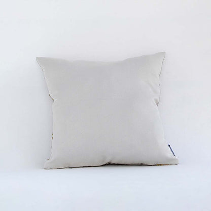 Side view of the geometric embroidered cushion showing its soft filled shape and raised textured pattern.