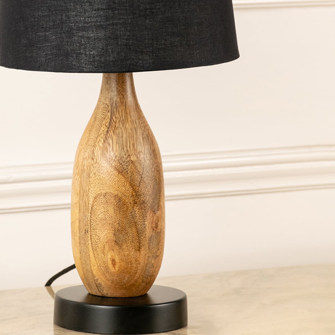 Natural wood lamp base with organic grain texture showcasing artisan craftsmanship and contemporary decorative appeal.