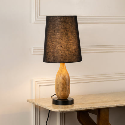 Table lamp with dark fabric shade and wooden base perfect for warm bedroom or living room table decor placement on clean background.