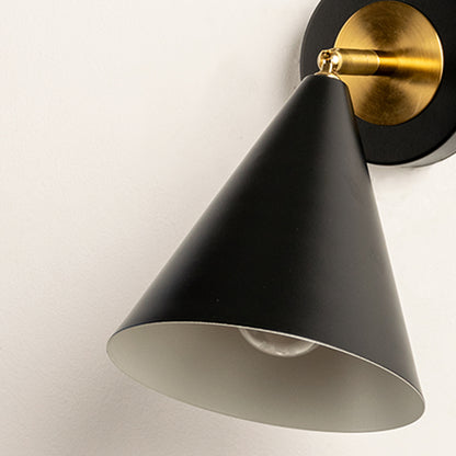 Closeup of black metal wall light with cone shade and gold mount showcasing smooth finish for modern interior decor styling.