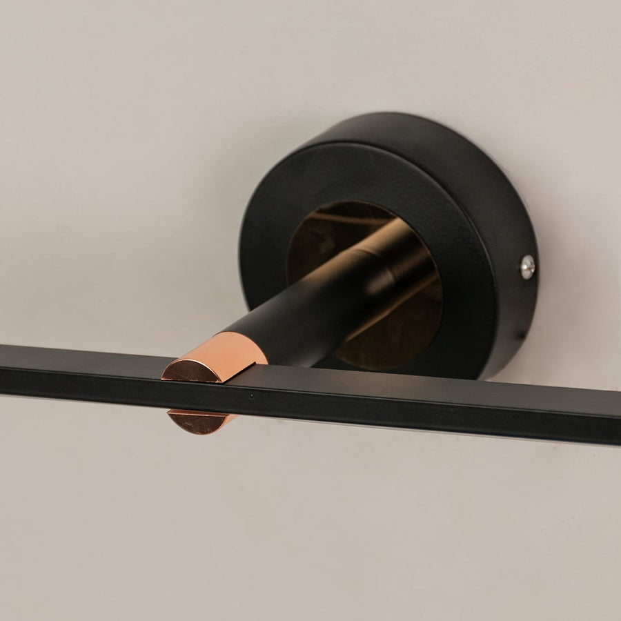 Black metal picture light with gold accent detailing showcasing premium craftsmanship and contemporary design appeal.