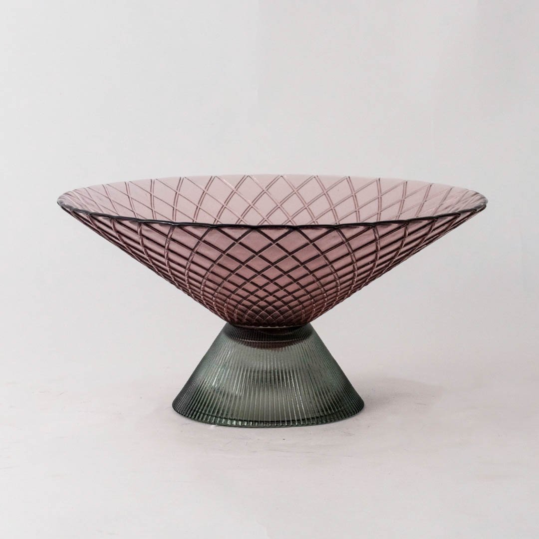 Smoky pink glass decorative bowl with green pedestal base for elegant tabletop styling and contemporary home decor.
