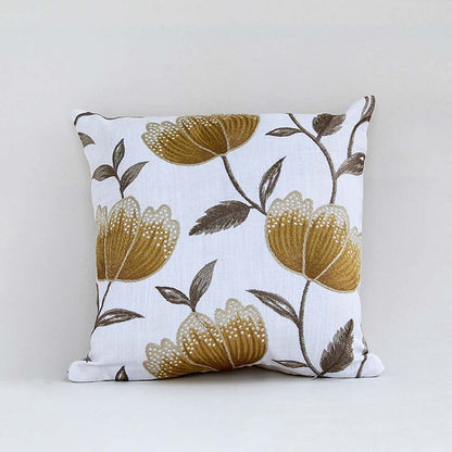 White cotton cushion cover with large golden botanical motifs providing a premium nature inspired décor accent with a breathable soft and skin friendly material finish.