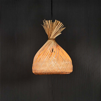 Handmade rattan pendant light with tied top woven shade displayed on black background for rustic home decor lighting.