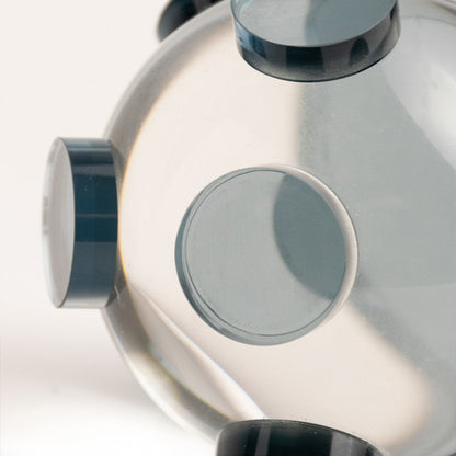 Closeup of clear glass decorative sculpture with circular design showcasing premium craftsmanship and modern styling.