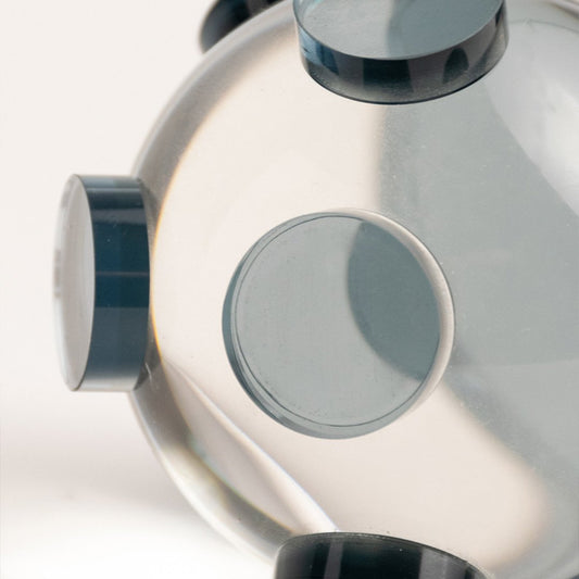 Closeup of clear glass decorative sculpture with circular design showcasing premium craftsmanship and modern styling.
