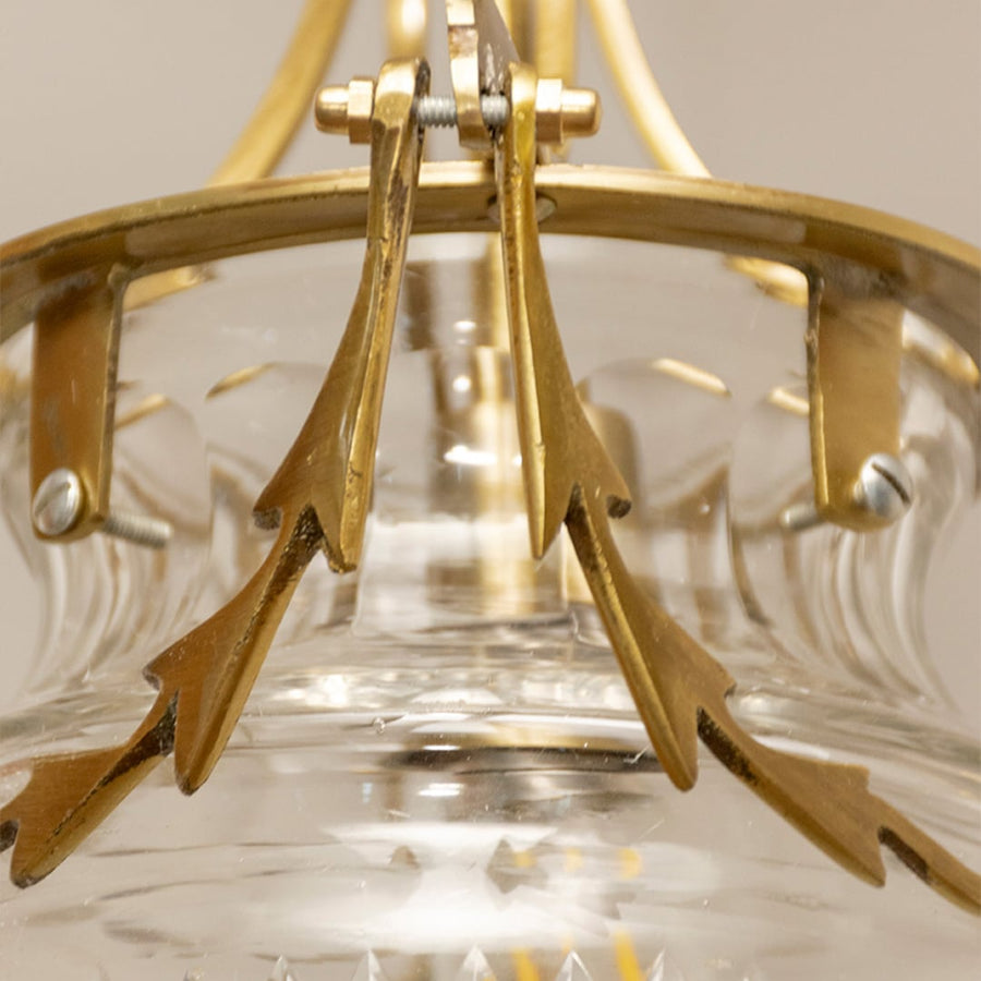 Detailed view of textured glass pendant light with antique metal accents highlighting artisan design and luxury appeal.