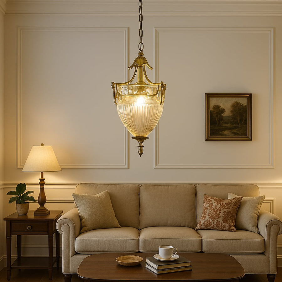 Pendant light with antique metal frame and textured glass shade enhancing modern living room decor with warm elegance.