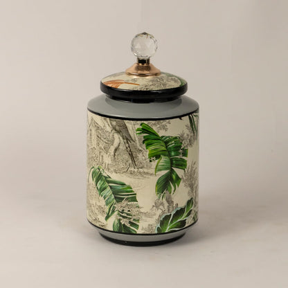 Side angle of tropical bird jar showing smooth cylindrical shape glossy finish and tropical foliage design.