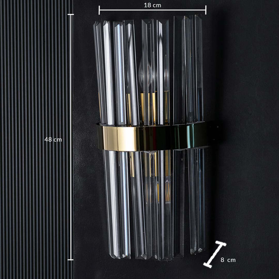 Crystal wall light shown with dimensions measuring 48 cm in height 18 cm in width and 8 cm in depth with clear rods and a polished gold band.
