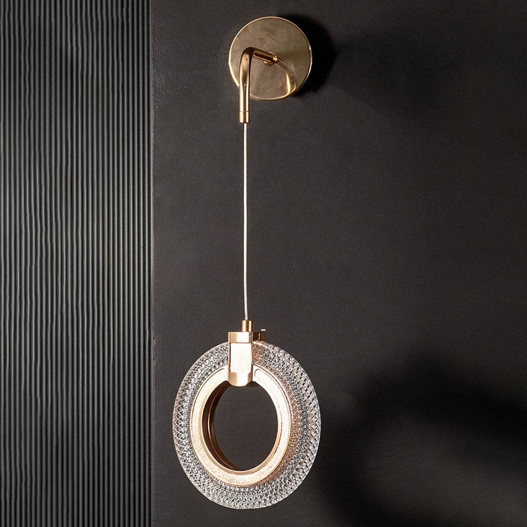 Modern gold crystal wall light turned off shown on black wall highlighting sleek metal and crystal design.