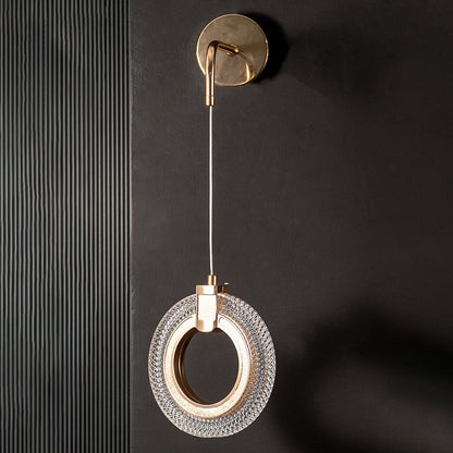Modern gold crystal wall light turned off shown on black wall highlighting sleek metal and crystal design.