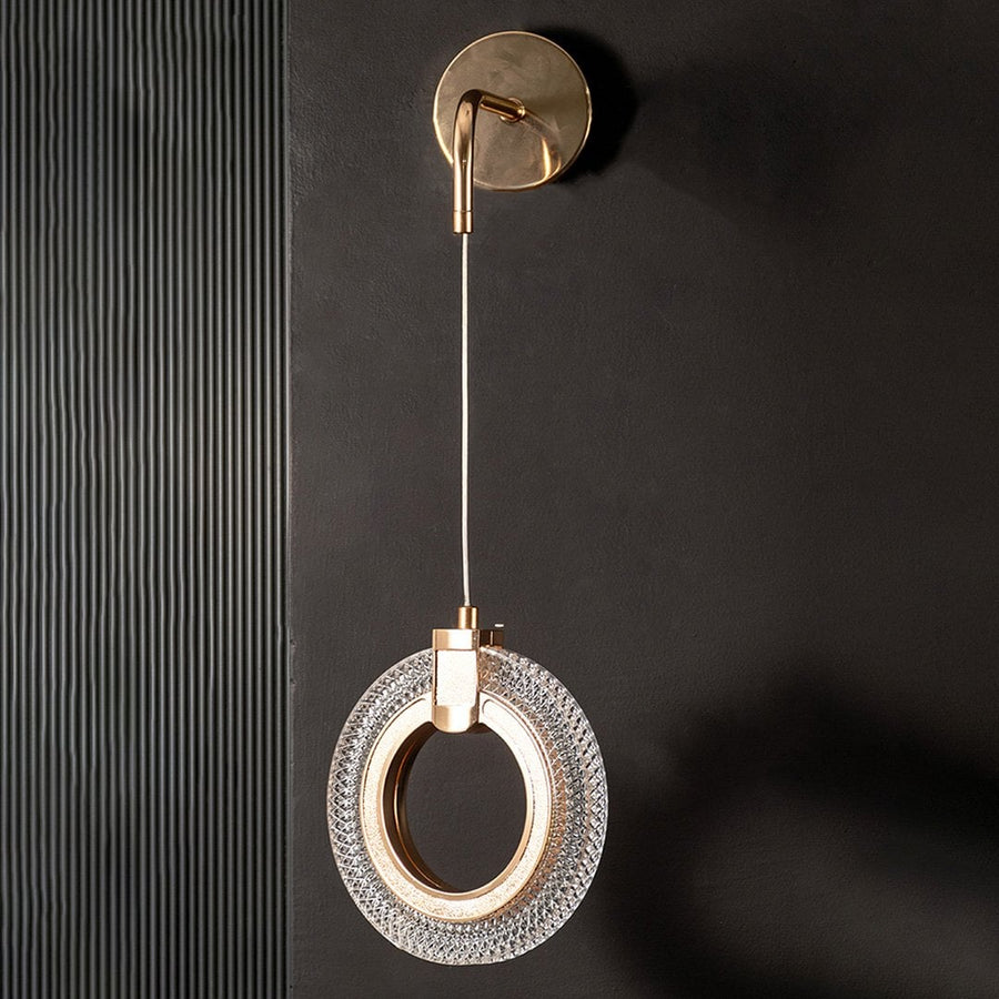 Modern gold crystal wall light turned off shown on black wall highlighting sleek metal and crystal design.