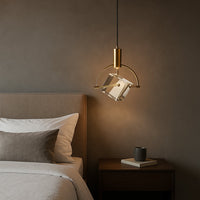 Crystal pendant light beside bed with warm illumination adding luxurious modern elegance and ambient bedroom decor appeal.