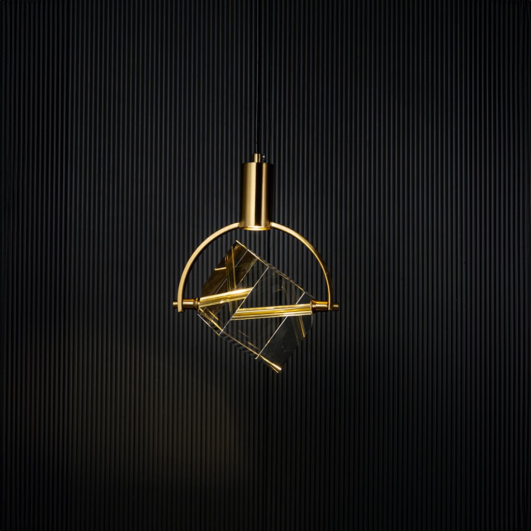 Crystal cube pendant light glowing on black background with golden frame and elegant modern design for interiors.
