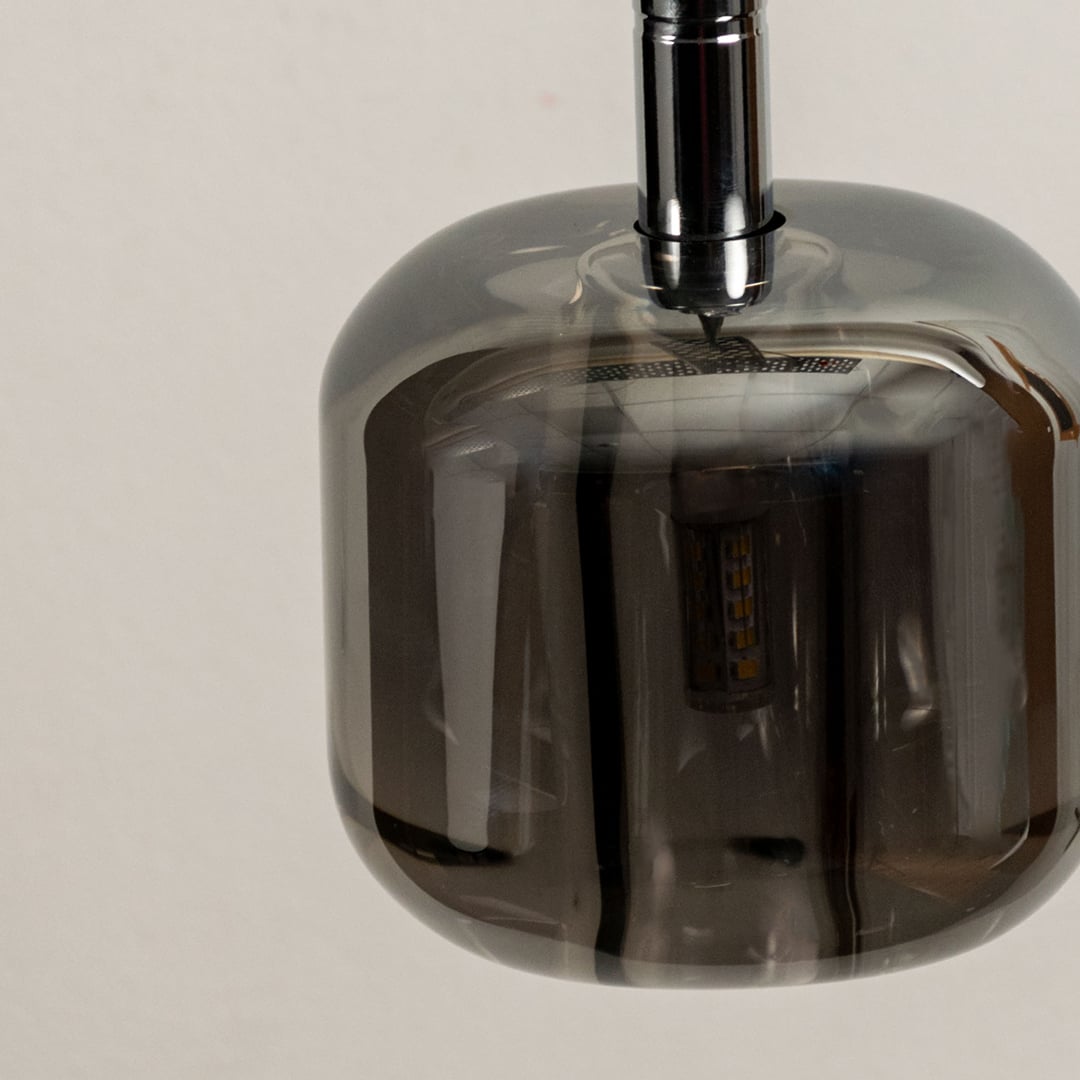 Close up of the amber glass pendant light emphasizing its sleek design and warm glow perfect for modern interiors.