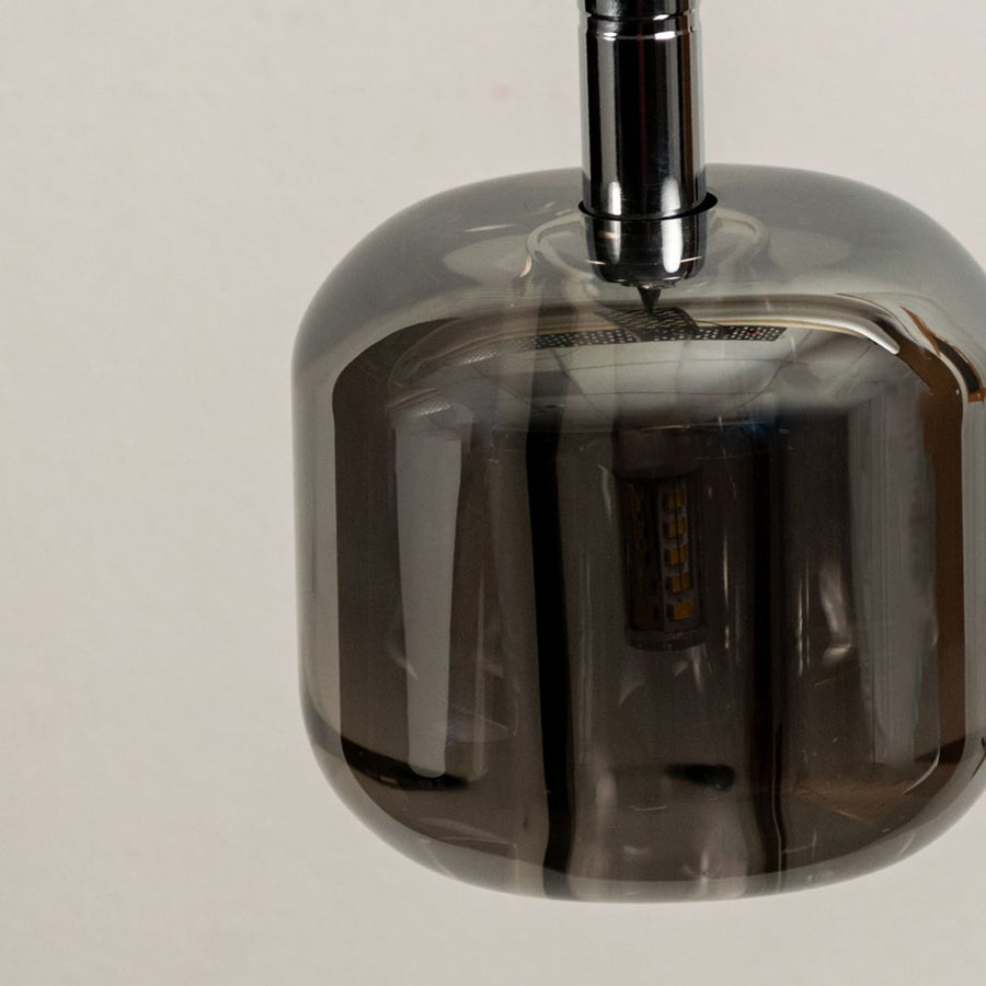 Close up of the amber glass pendant light emphasizing its sleek design and warm glow perfect for modern interiors.