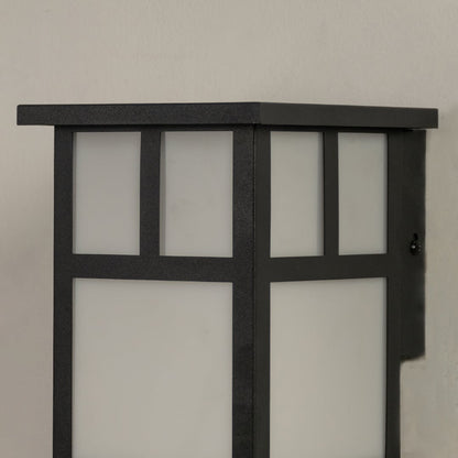 Closeup view of the black outdoor wall light highlighting its structured frame and frosted glass panels.
