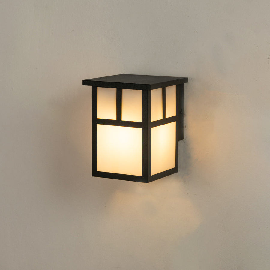 Modern black rectangular outdoor wall lantern on white background featuring frosted glass panels with geometric frame overlay.