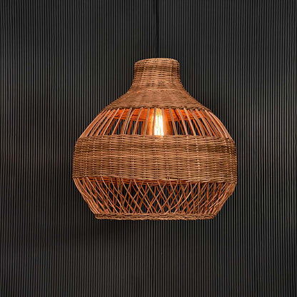 Natural rattan pendant light glowing beautifully on black background highlighting texture and woven detail.