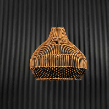Rattan and black woven pendant light on black background showcasing elegant craftsmanship and natural texture.