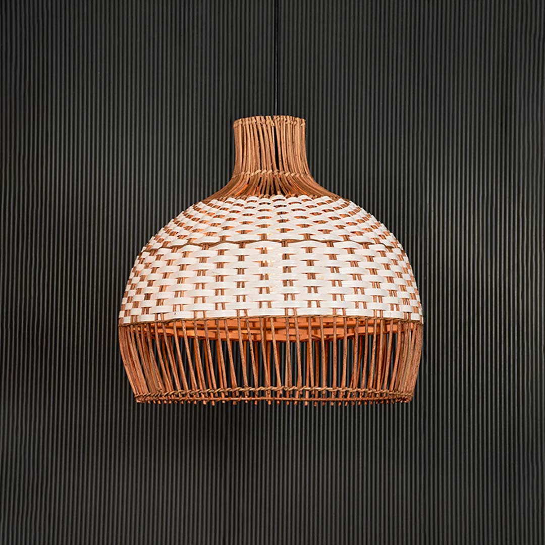 Natural and white rattan pendant light illuminated with warm glow for inviting living spaces.