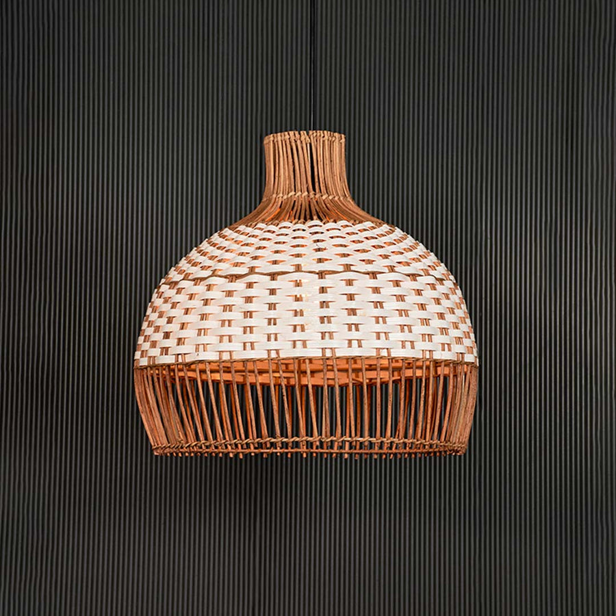 Natural and white rattan pendant light illuminated with warm glow for inviting living spaces.