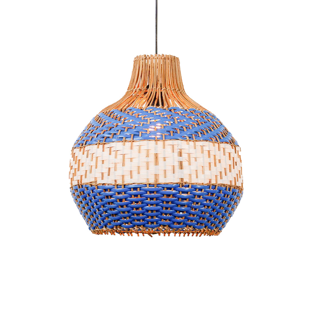 Handwoven rattan pendant light with blue and natural pattern and rounded shape hanging against soft neutral wall background for boho decor styling.
