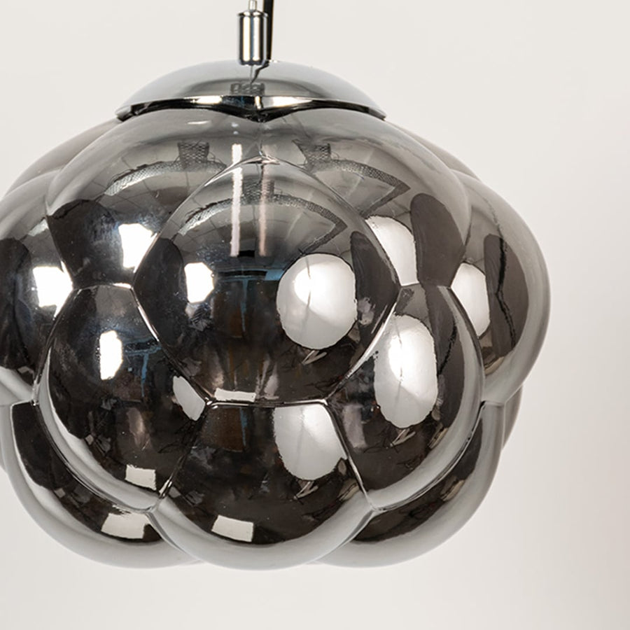 Closeup of smokey glass bubble pendant light with round reflective shade designed for elegant modern interiors.