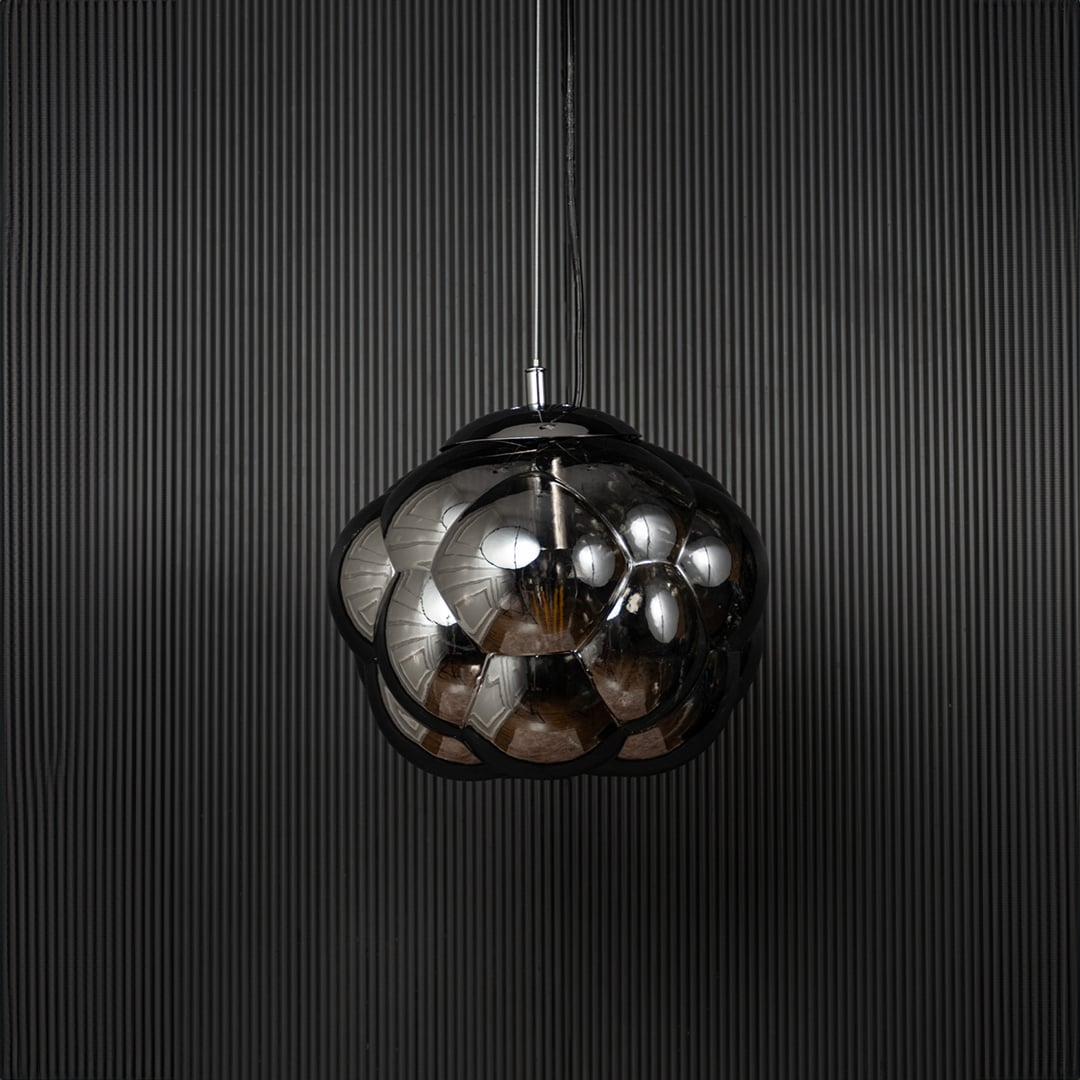 Smokey glass bubble pendant light bulb off on black background with round reflective shade for modern home decor.