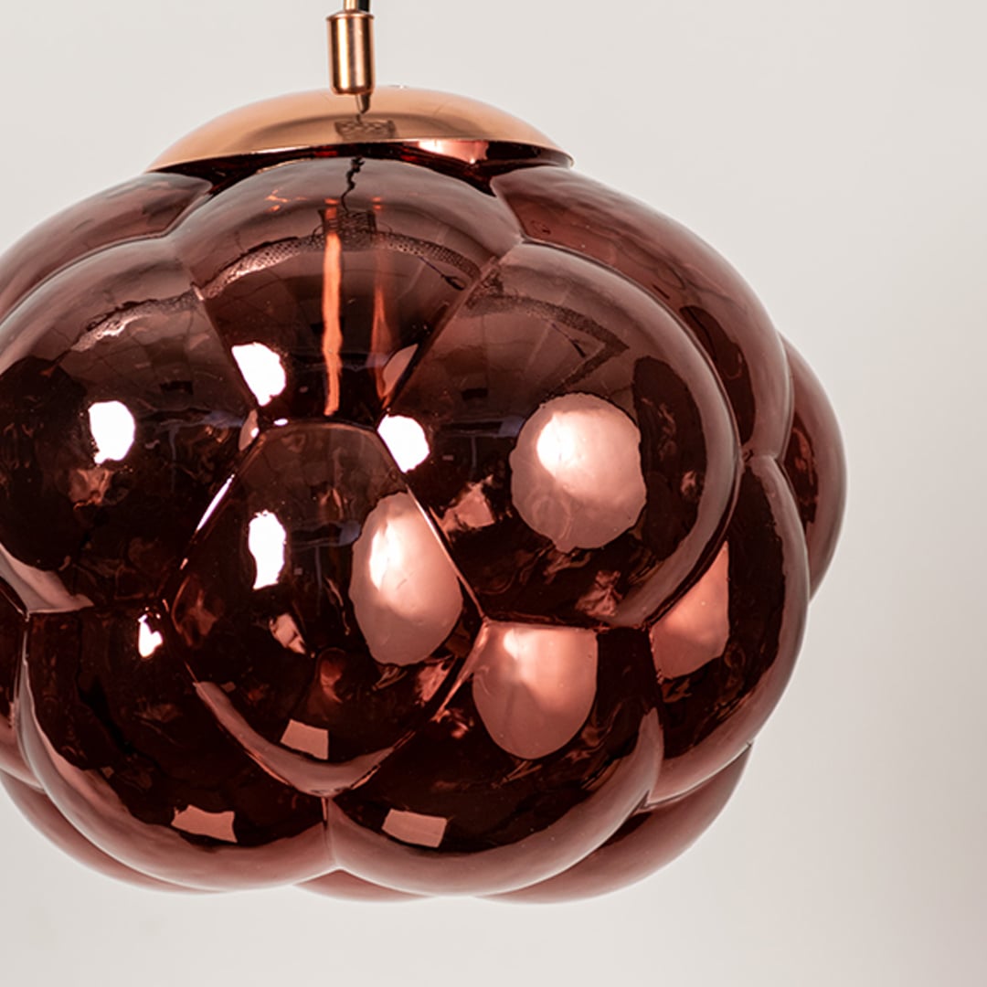 Closeup of brown glass bubble pendant light with artistic round shade designed for stylish modern home interiors.