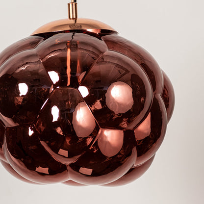 Closeup of brown glass bubble pendant light with artistic round shade designed for stylish modern home interiors.