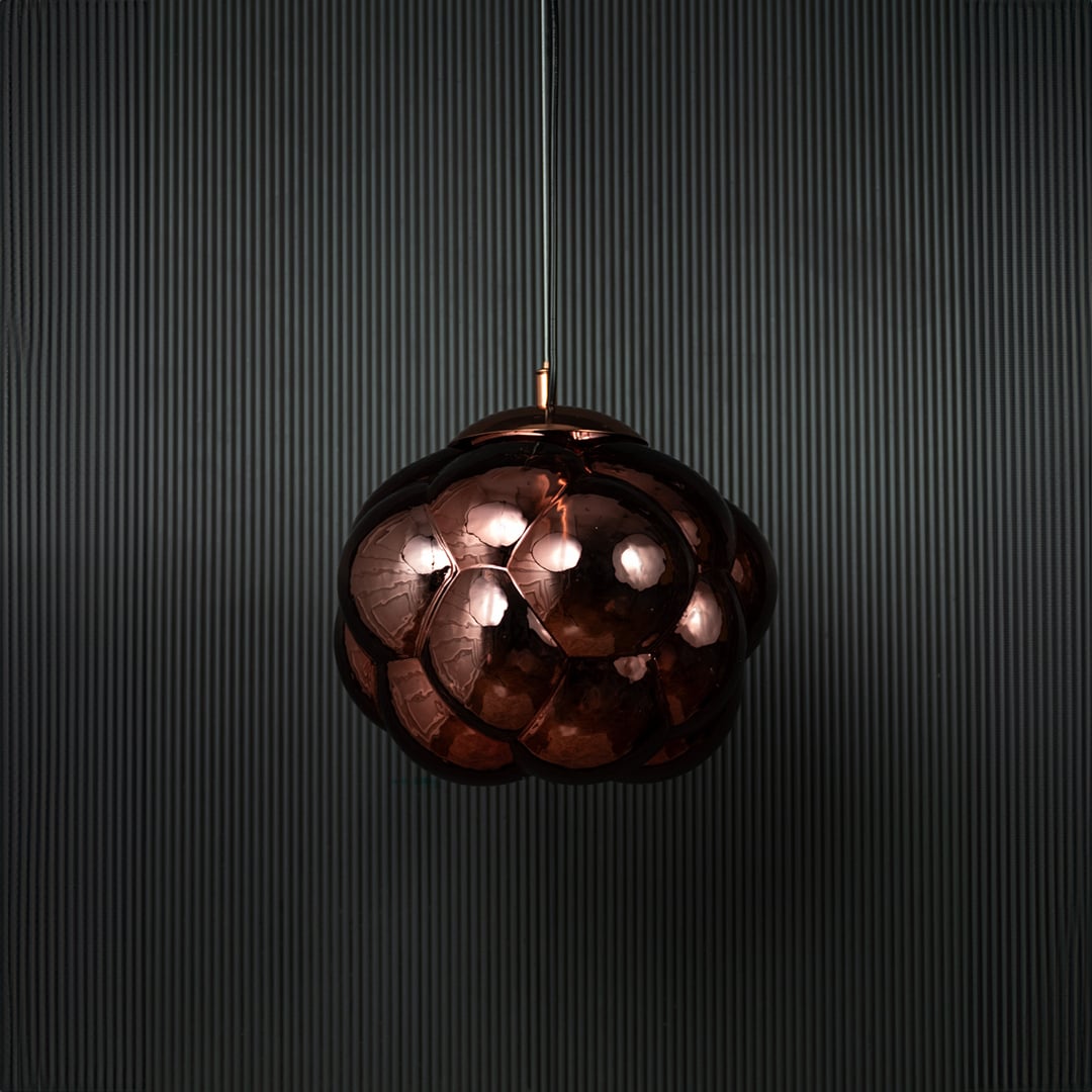 Brown glass bubble pendant light bulb off on black background featuring artistic round shade and modern design.