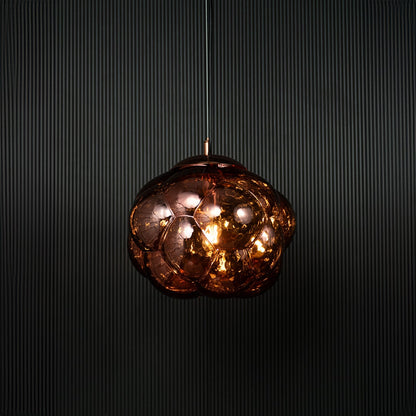 Brown glass bubble pendant light glowing on black background with reflective surface and artistic round design.