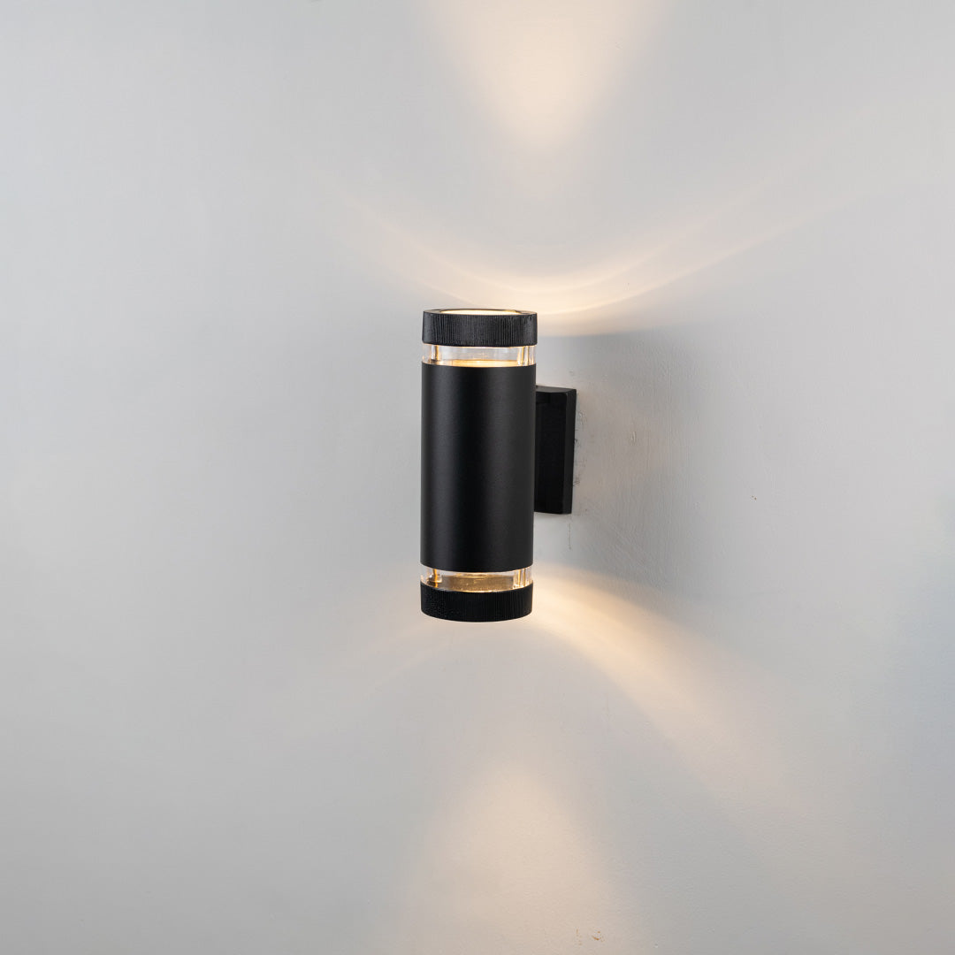 Black metal outdoor wall light on white background with gold accent bands for elegant exterior decor.