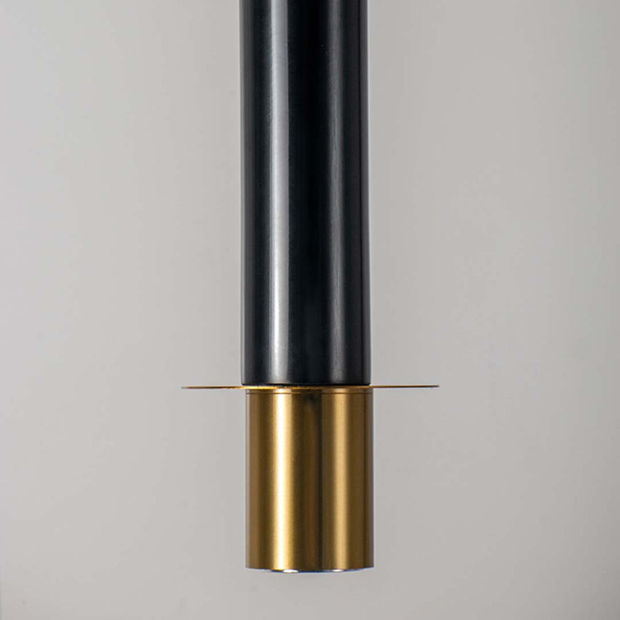 Closeup of black and gold cylindrical metal pendant light showcasing detailed finish and premium hanging ceiling design.