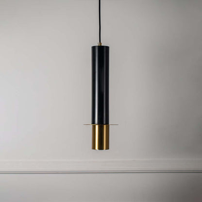 Contemporary black and gold pendant light with cylindrical shape featured against minimal off white background for style.