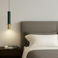 Dark green metal pendant light with gold accents beside the bed creating warm modern elegance indoors.