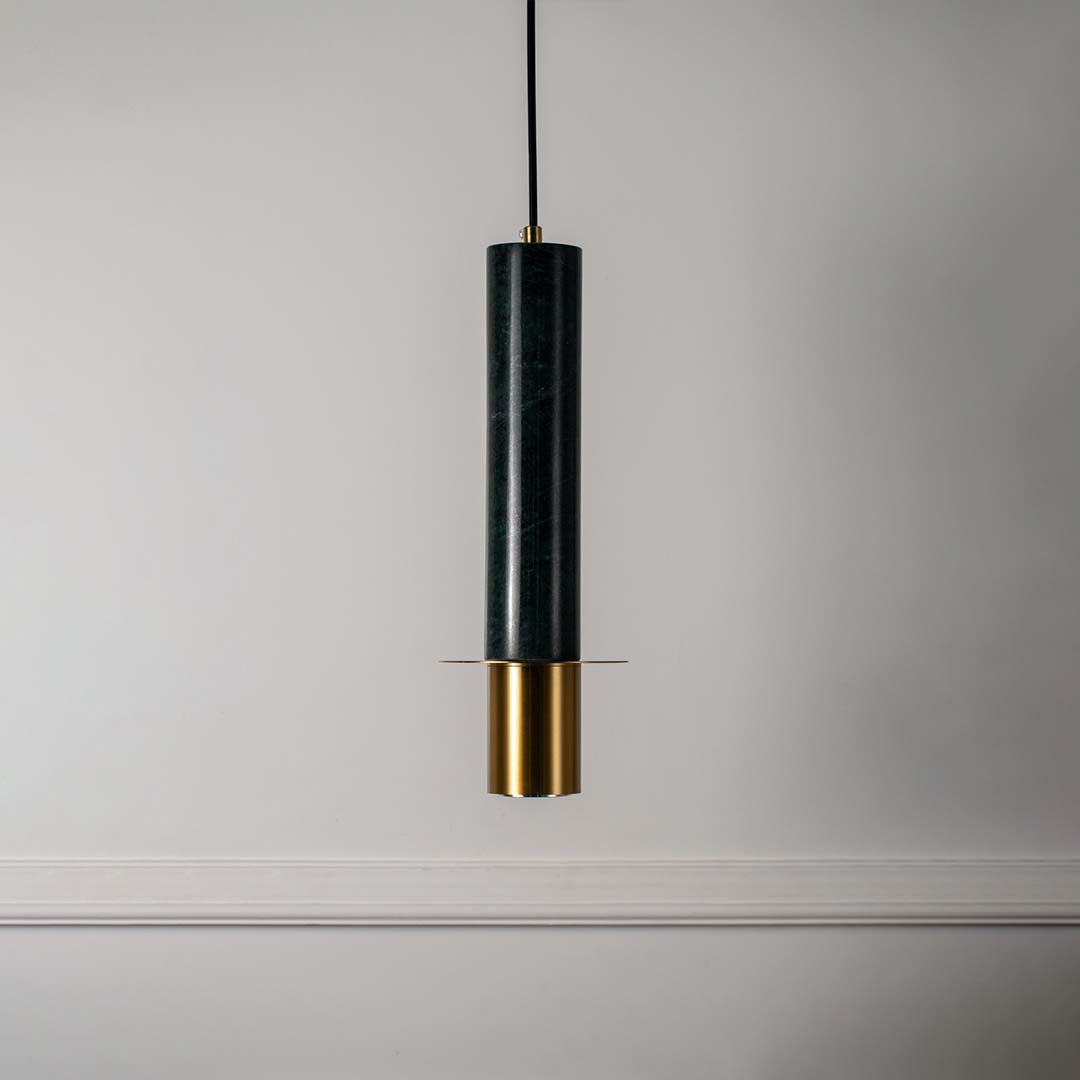 Modern green marble pendant light with brass gold detailing and sleek cylindrical shape turned off highlighting rich texture.