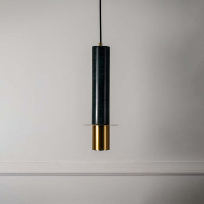 Modern green marble pendant light with brass gold detailing and sleek cylindrical shape turned off highlighting rich texture.