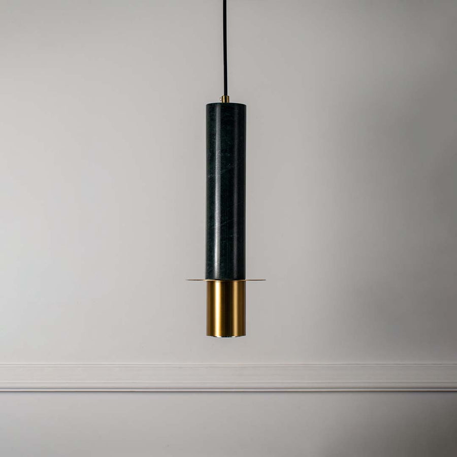 Modern green marble pendant light with brass gold detailing and sleek cylindrical shape turned off highlighting rich texture.