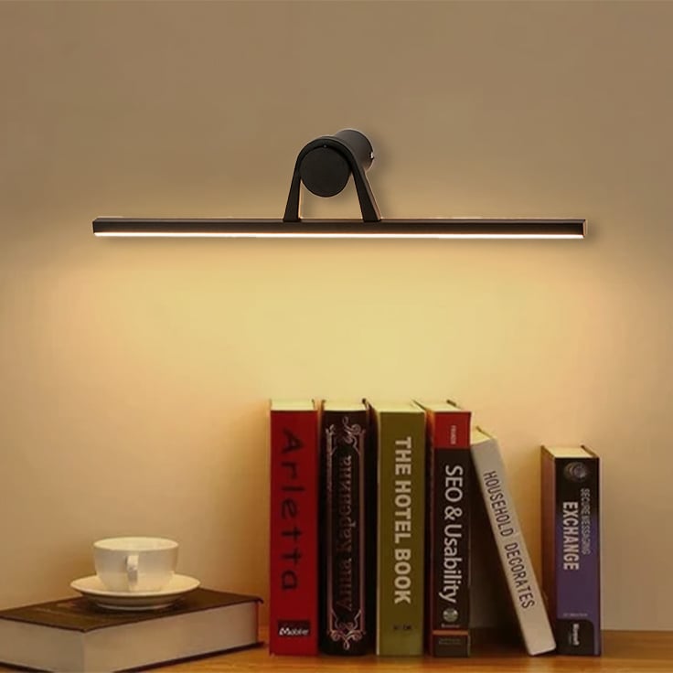 Black metal picture light styled above artwork on a modern wall creating warm gallery style accent lighting.