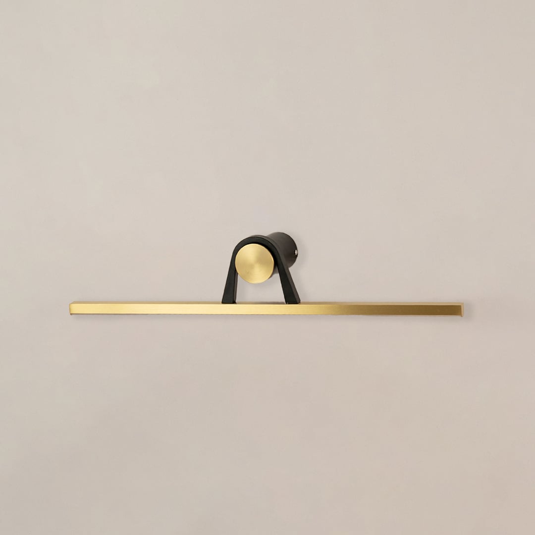 Black and gold metal picture light with sleek linear design for artwork mirror and decorative wall lighting.