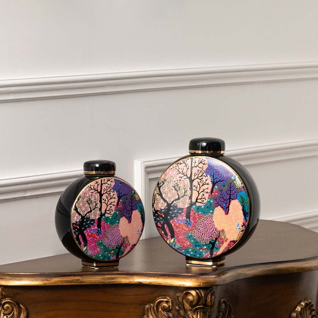 Pair of black floral jars with vibrant detailing perfect for modern décor styling on console tables or display shelves.