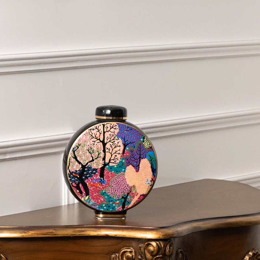 Round ceramic decorative jar with artistic tree design displayed on a console table for elegant home decor styling.