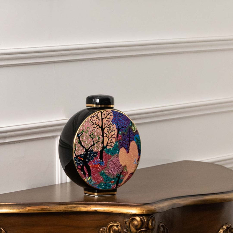 Round vase with pastel and pink floral artwork on black background shown in a closeup view emphasizing color richness brushwork detail and handcrafted décor ideal for designer interiors.