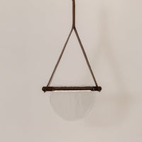 Brown metal pendant light with smoke glass diffuser featuring minimalist decorative styling.